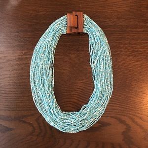 Beaded necklace with wooden broche